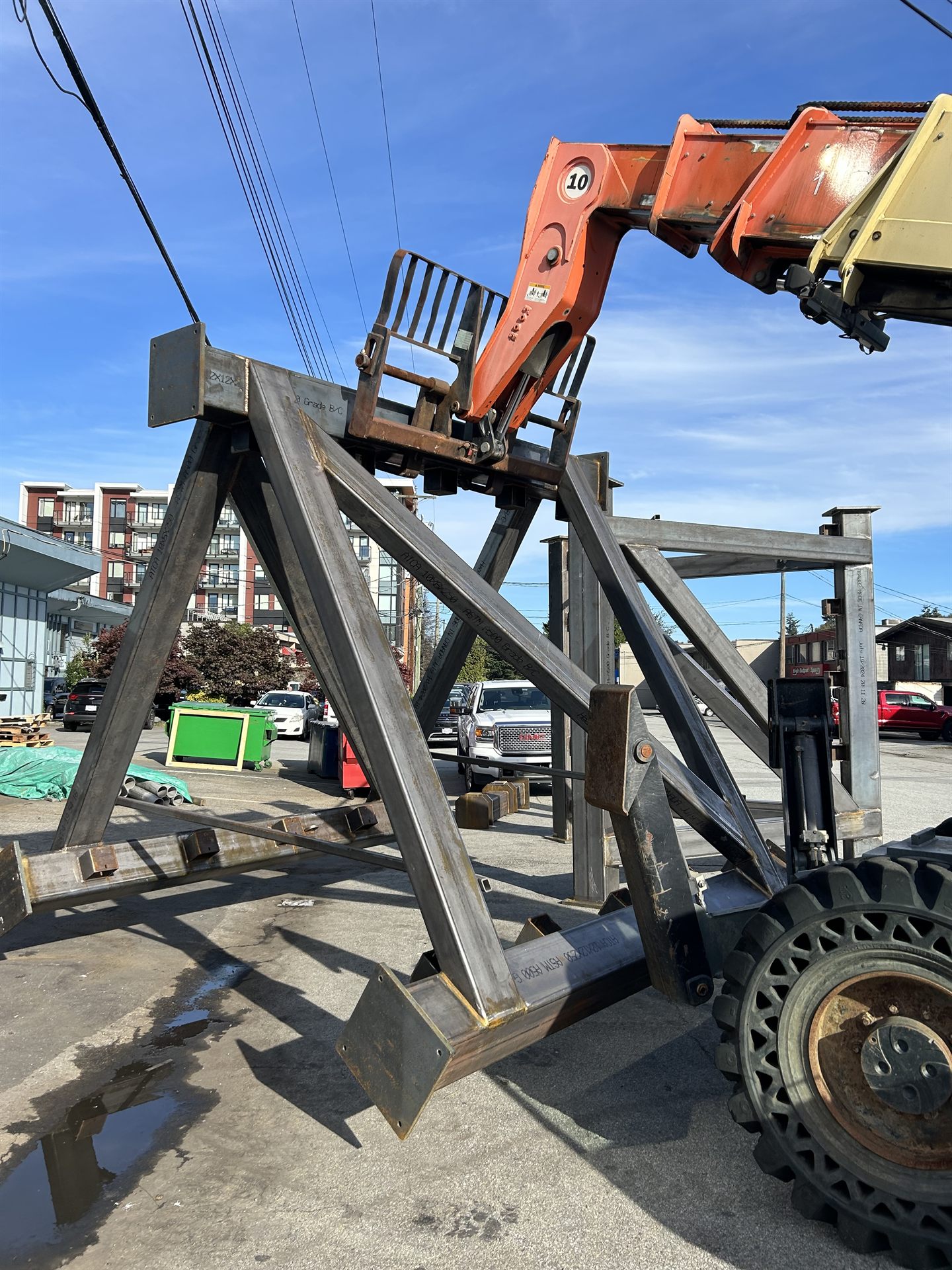 Heavy structural steel members handled by telehandler