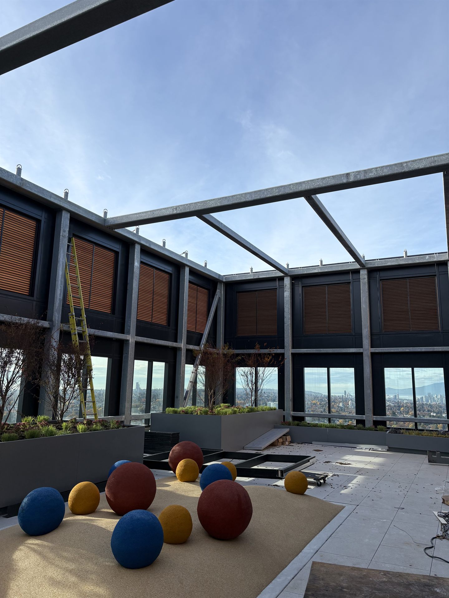 Steel canopy framing with cedar-look infill panels