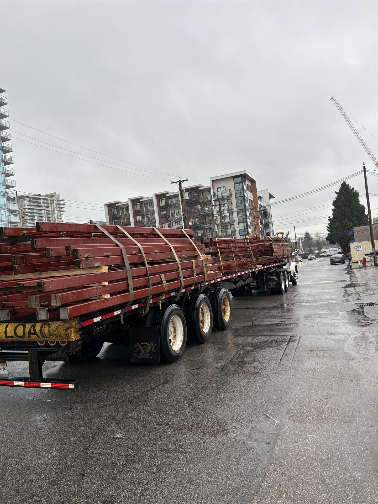 Primed structural steel loaded for site delivery